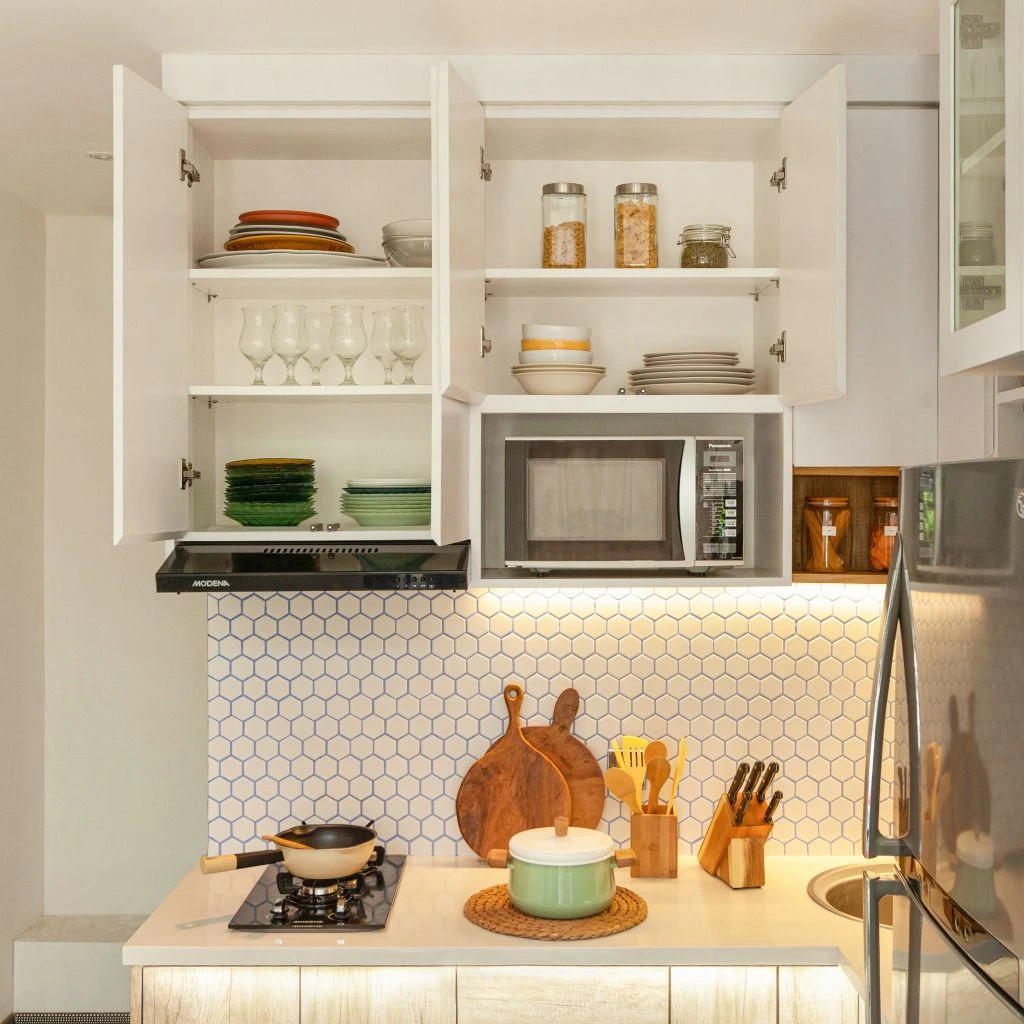 Small renovated kitchen with open shelving and brass hardware