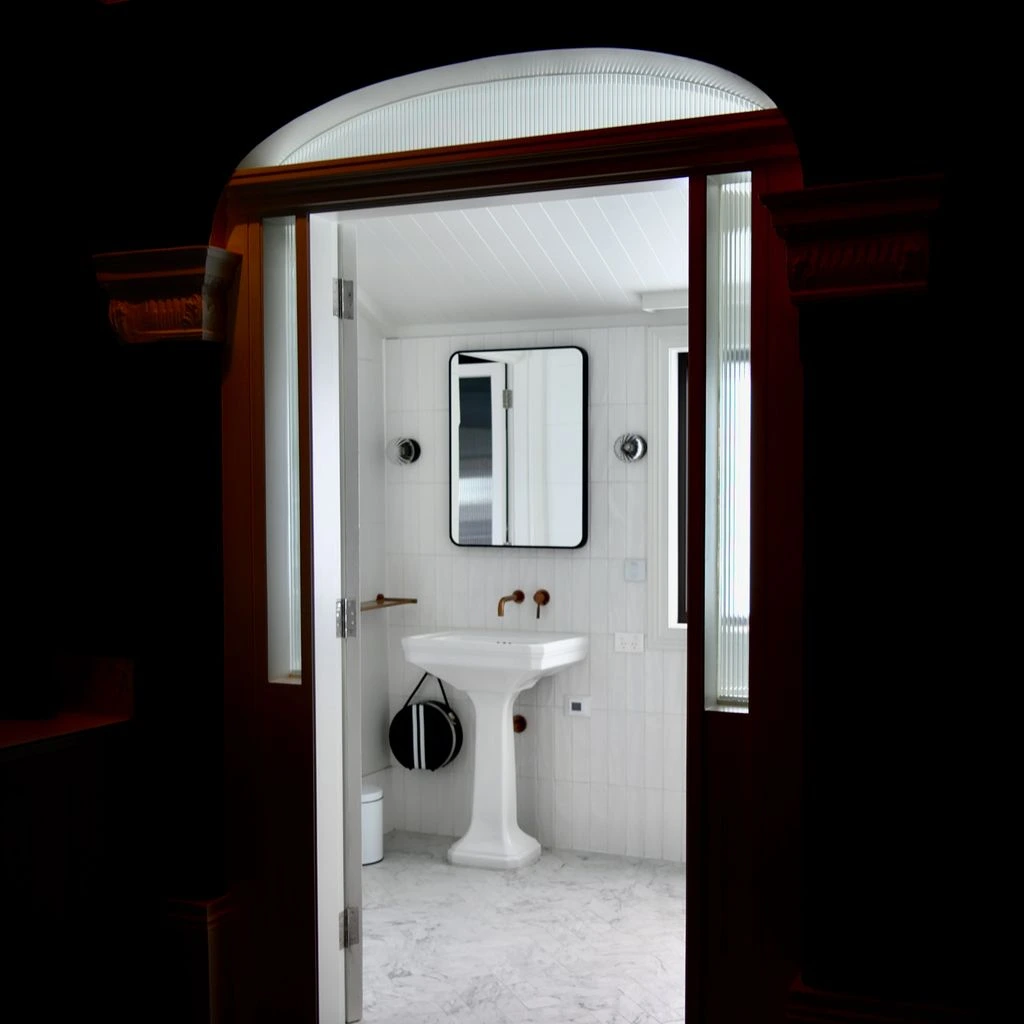 Small bathroom with terracotta tile and brass faucet